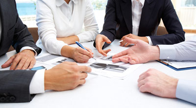 industry professional executives discussing a project around a table